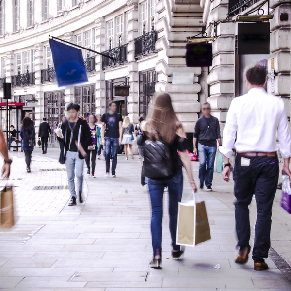 People walking down a busy shopping street in London
