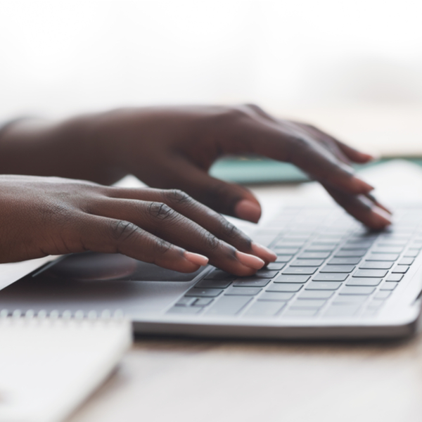 A person typing on a laptop