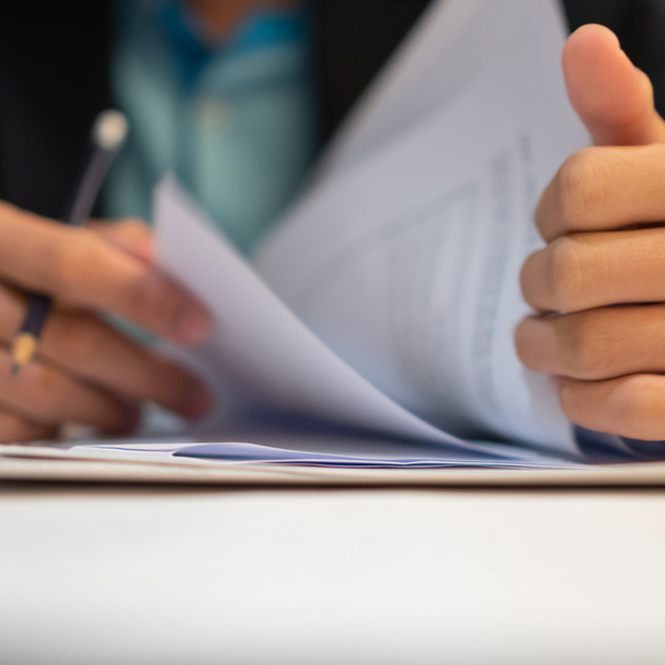 Close up of a man looking through some paperwork