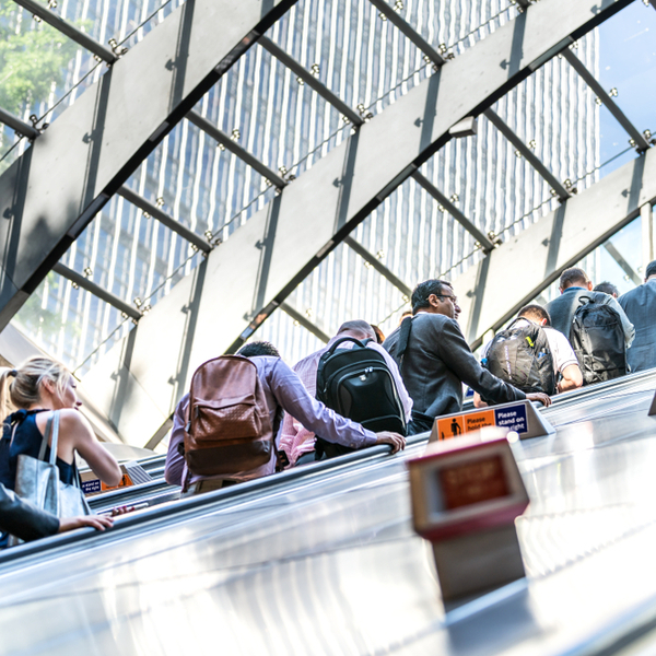 Commuters riding an escalator on the London Underground.