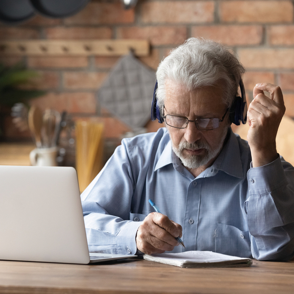 An older man working on a laptop.