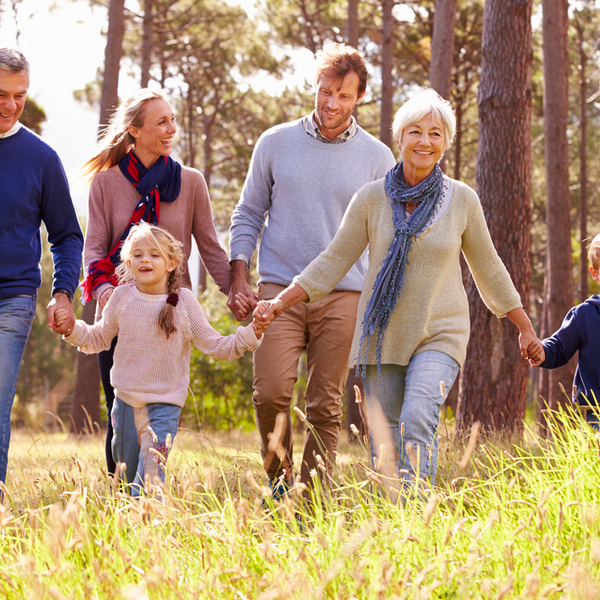 A multi-generational family walking through the countryside.