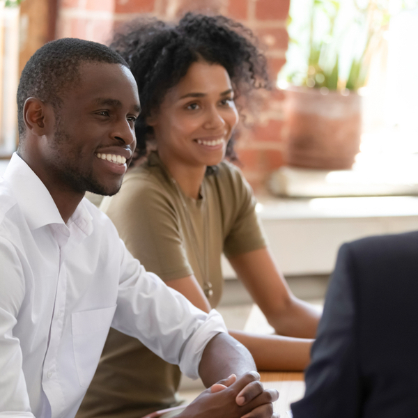 A couple talking to a financial planner.