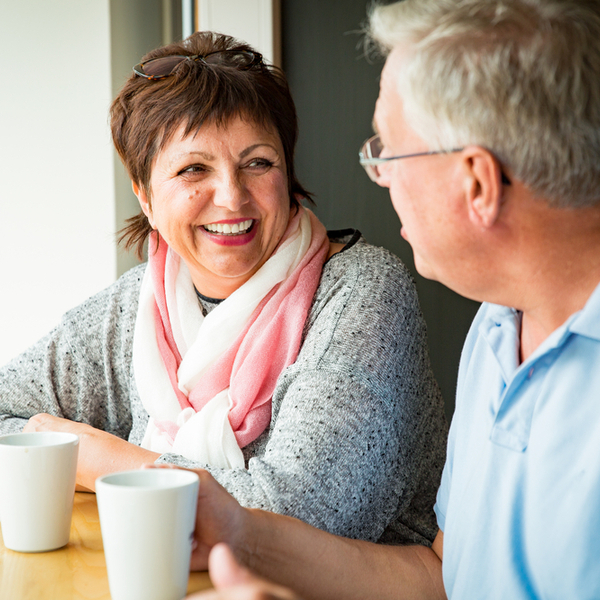 A couple talking over a coffee.