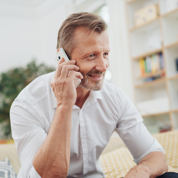 A man taking a phone call at home.