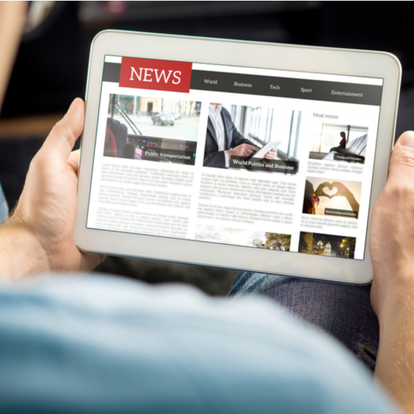 A man reading the news on a tablet.