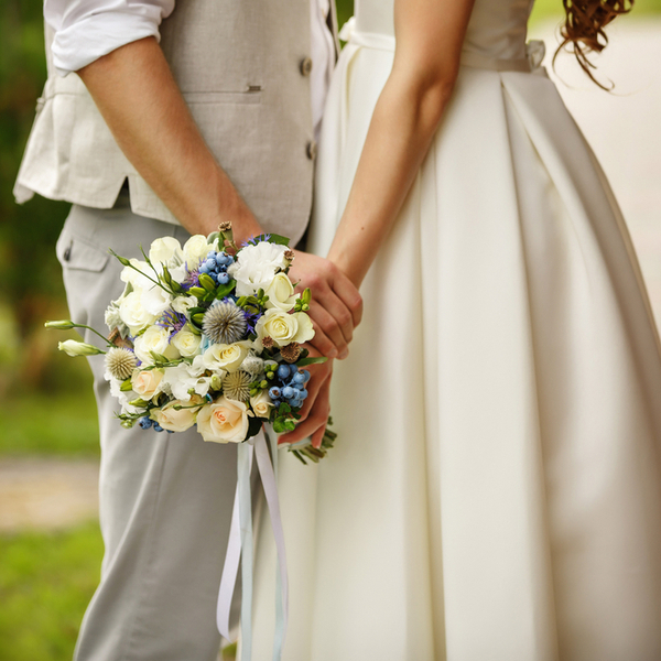 Wedding bouquet in the hands of a bride and groom.