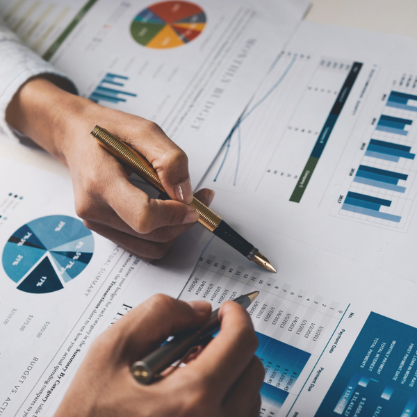 Two people looking at financial documents.