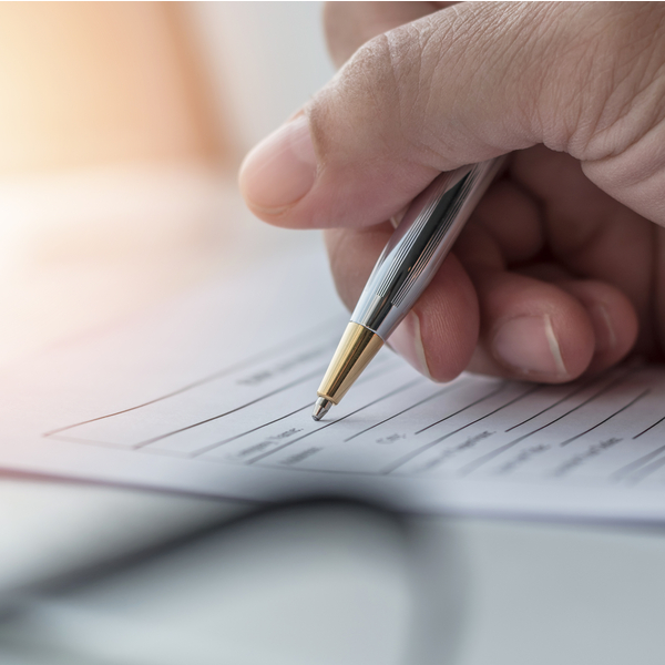 A person filling in paperwork.