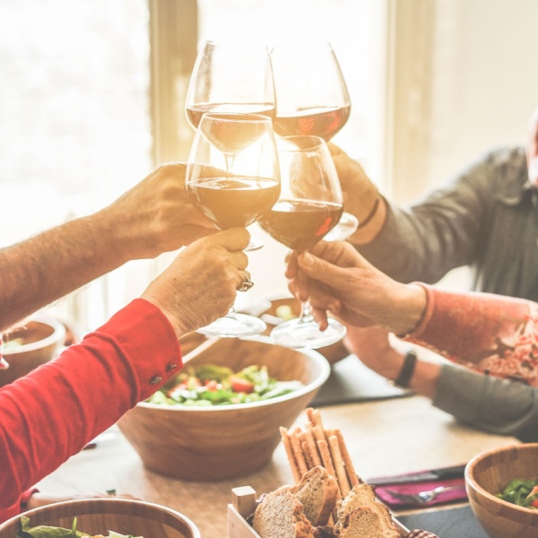 A group of friends cheering with wine.