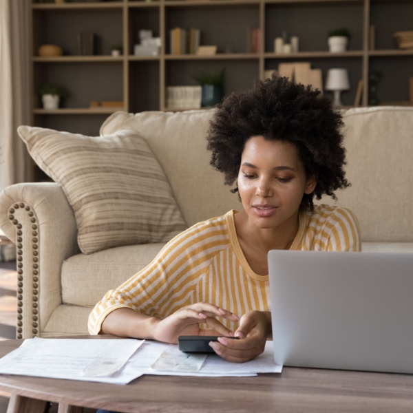 A woman reviewing some paperwork at home.