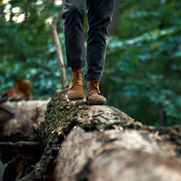 A man walking on a log.