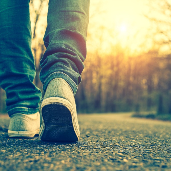 A close-up of someone walking on a path.
