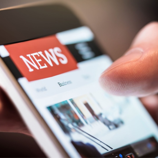 A person using a smartphone to read the news.
