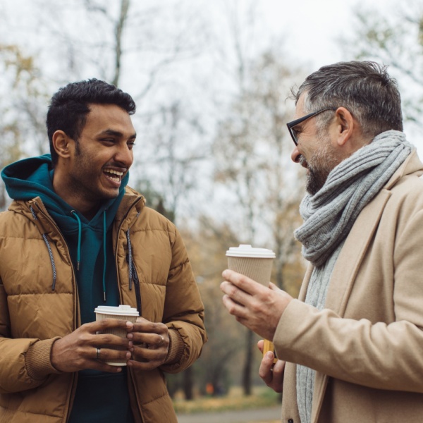 Two men talking together outdoors.
