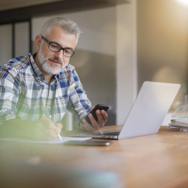 A man using a computer in a home office.