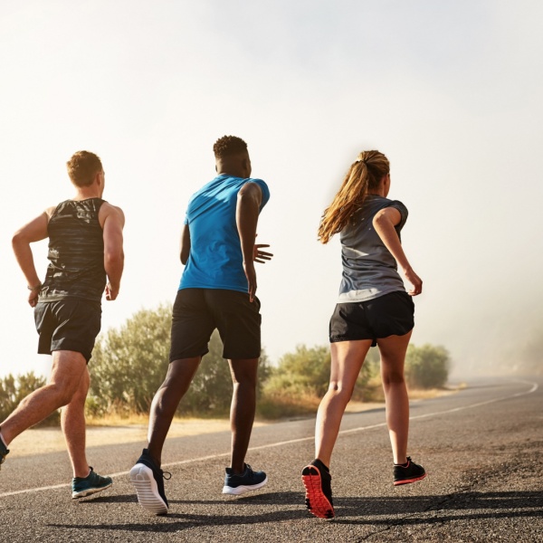 Three people running outdoors.