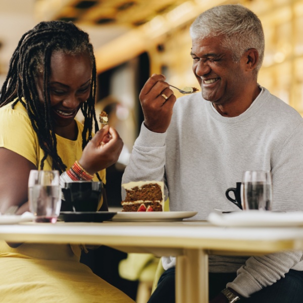 A couple laughing together at a café.
