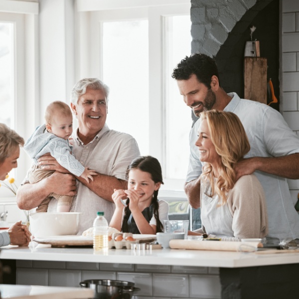 Three generations of family cooking in the kitchen
