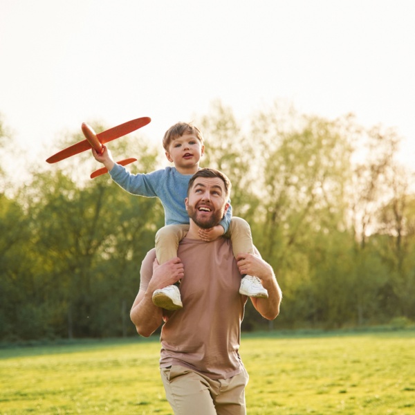 A father with a child sitting on his shoulders.