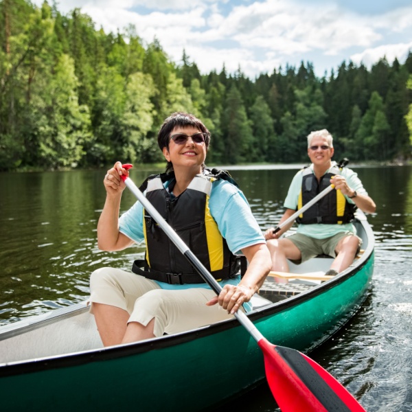 A couple on holiday taking a canoe ride.