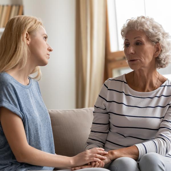 A mother and adult daughter talking.