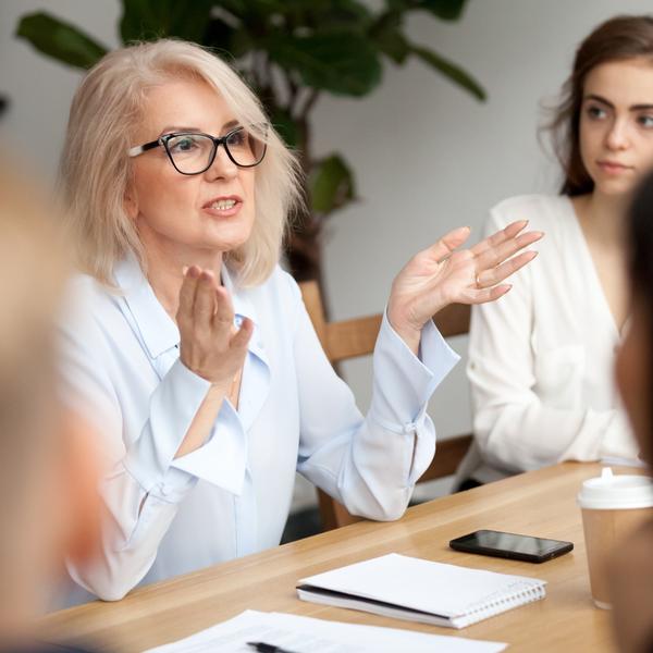 A woman talking during a work meeting.