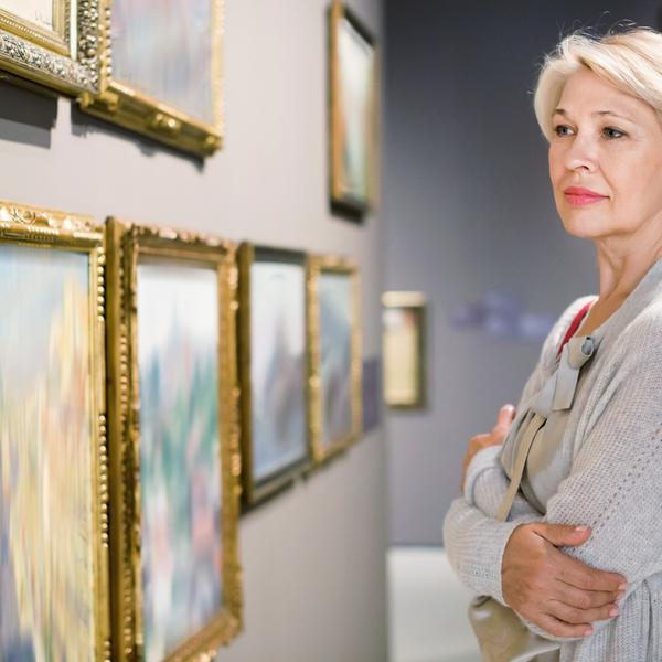 A woman looking at art in a gallery.