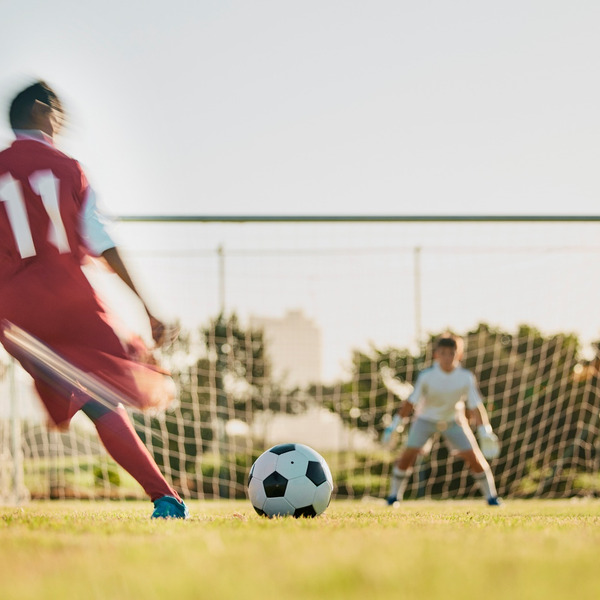 A footballer taking a shot at a goal.