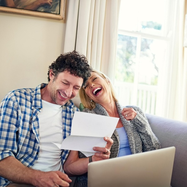 A happy couple reviewing paperwork.