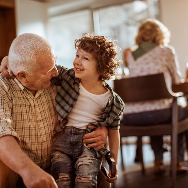 Grandfather hugging his grandchild.