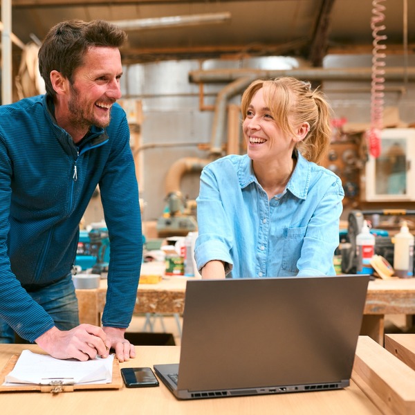 Two people in a woodwork workshop.