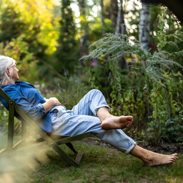 A woman relaxing in a garden.