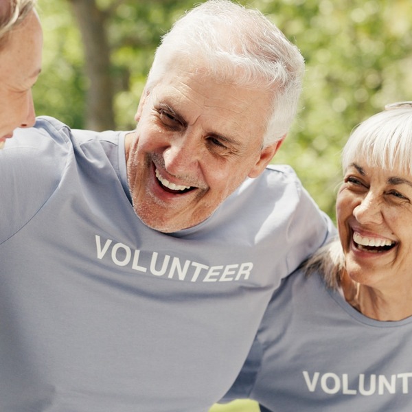 Happy senior people wearing “volunteer” t-shirts